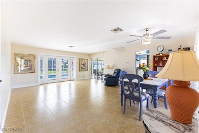 Dining area with ceiling fan, light tile patterned