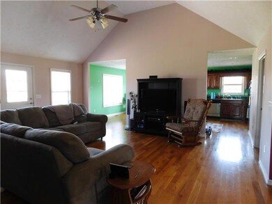 Large great room with vaulted ceiling, recessed lighting and hardwood floors