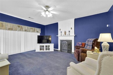 Carpeted living room featuring a fireplace, visibl