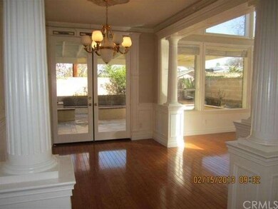 Dining Room with Custom Chandelier & Formal Pilars