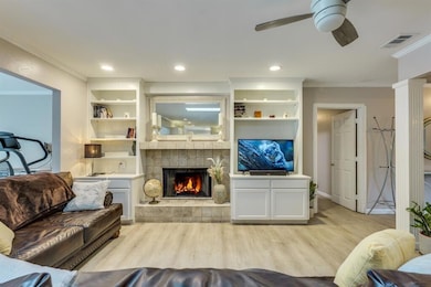 Living room featuring ornamental molding, wood fi
