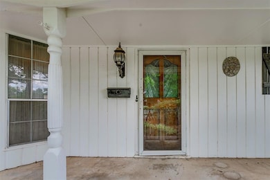 Entrance to property featuring covered porch