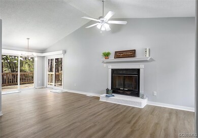 Living room featuring NEW LVP flooring, vaulted ce