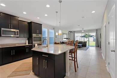 View of Kitchen into eat in area and family room