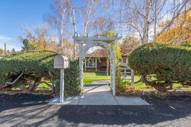 View of property's community with a lawn and a pergola