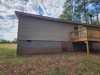 View of property exterior featuring a deck