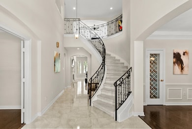 This amazing entry with soaring ceilings, stunning