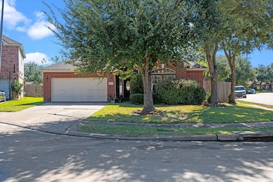 This charming single-story brick home features a two-car garage and a well-maintained front yard with mature trees and shrubs. It's situated on a corner lot, offering ample space and a welcoming curb appeal.