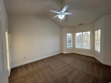 Spare room featuring carpet floors, ceiling fan, a
