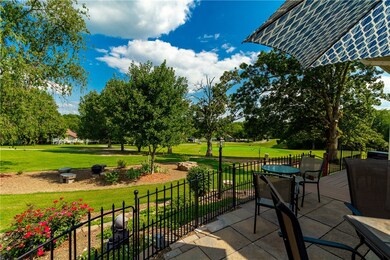 You have a wonderful expanded patio area overlooking your flower gardens and the the #4 green of the Brittany golf course.