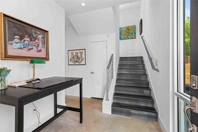 Stairway with baseboards, concrete floors, and re
