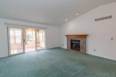 Vaulted ceilings, slider to sunroom, and gas-log f