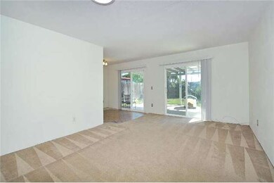 The spacious living/dining room, with sliders to t