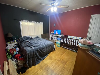 Bedroom with hardwood / wood-style floors and ceil