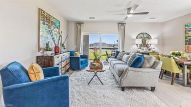 Living room with ceiling fan and light wood-type f
