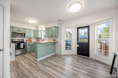View of Breakfast room, kitchen, and bay to deck.