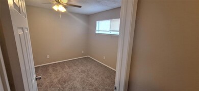 Spare room with ceiling fan, baseboards, dark carp
