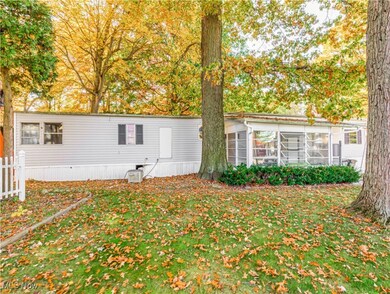Other side of the front of the mobile home showing screened-in porch