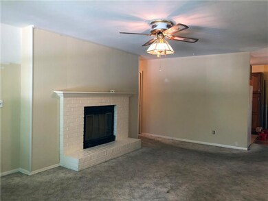 Living room has hardwoods under carpeting.