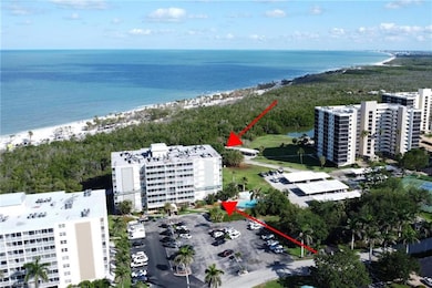 Aerial view of a nearby body of water and apartment complex / building