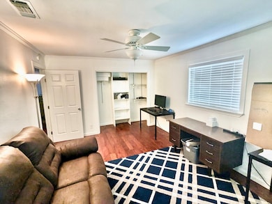 Office featuring visible vents, a ceiling fan, wo