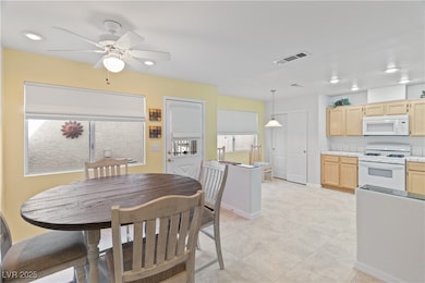 Dining room with recessed lighting, ceiling fan, and light tile patterned floors