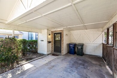 Covered parking and a side gate that leads to the 