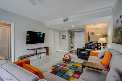 Living room with crown molding and light tile patt