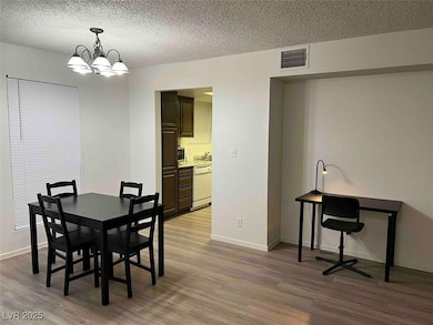 Dining space featuring wood finished floors, a cha