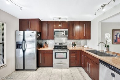 Kitchen featuring backsplash, appliances with stai