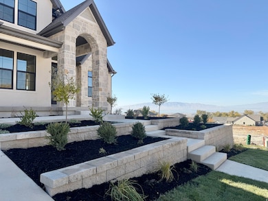 View of side of home featuring stone siding and a mountain view
