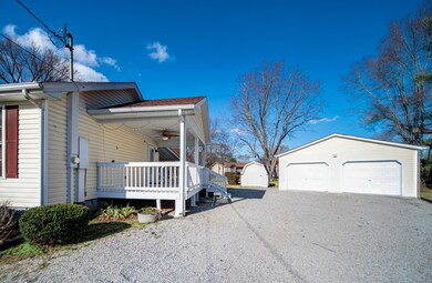 Charming 3-bedroom house on a spacious 1/2 acre lot with lush, mature trees, full shop, covered patio, and deck