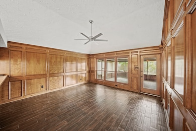 This inviting family room, featuring rich paneling
