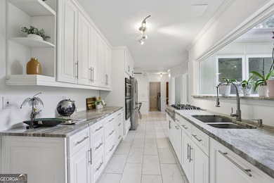 The fully Reimagined Kitchen is truly the heart of the home. Anchored by an impressive 7-foot Picture Window that fills the space with natural light, it features sleek Granite Countertops, Stainless Steel Appliances, and abundant storage   an ideal s