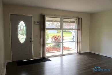 Spacious living area with wall to ceiling window a