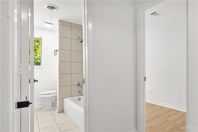 Bathroom with shower / bath combination and tile patterned floors