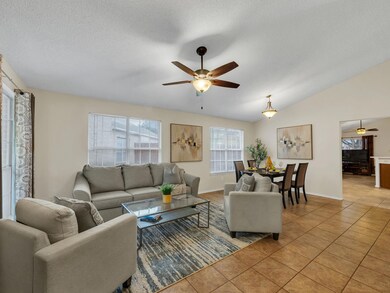 Living room with lofted ceiling, a textured ceilin