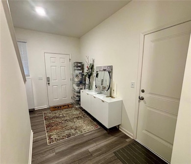 Foyer entrance with dark hardwood / wood-style flo