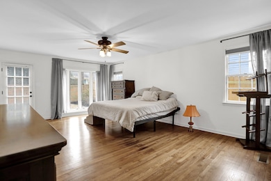 Bedroom featuring ceiling fan, access to exterior,