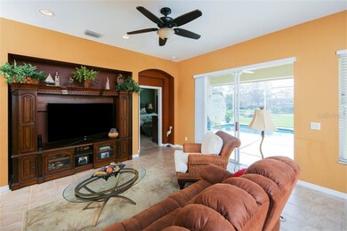 Living area with lanai and pool view