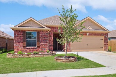 View of front facade featuring a garage and a front yard