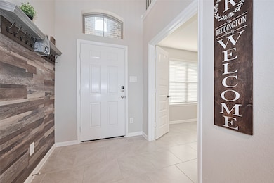 The bright and inviting foyer is filled with natur