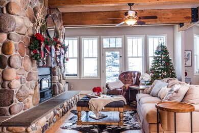 Living area off kitchen with rock fireplace