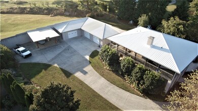 OVERLOOKING HOME, THREE GARAGE STALLS, WITH WORKSH