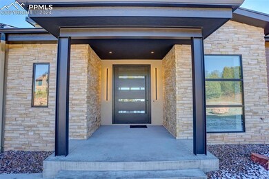 Covered front patio with ample exterior lighting, 