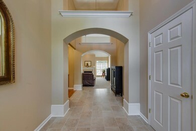 View of foyer offering extensive trim and arched entry way.