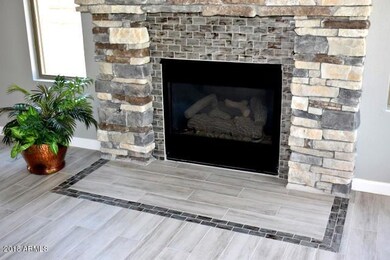 Glass tile inlay at fireplace and floor
