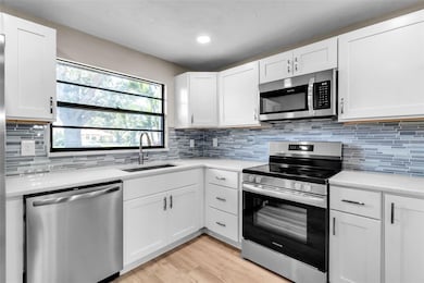 THE SUNNY KITCHEN OVERLOOKS THE PARKLIKE ENTRY.