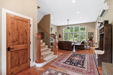 Front Entry Foyer Leads to Living Areas with Vaulted Ceilings and Floor-to-Ceiling Windows