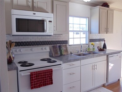 Kitchen has new appliances and tile back splash.